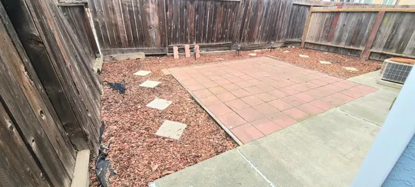 a backyard with table and chairs