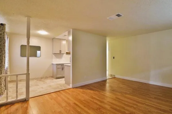 a view of a kitchen with a sink and a refrigerator