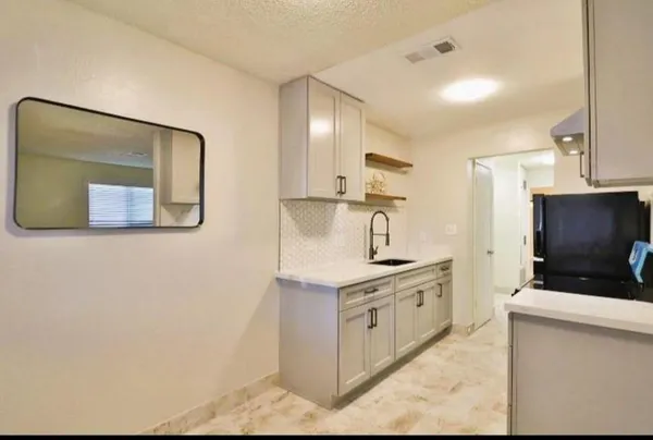 a kitchen with stainless steel appliances granite countertop a stove a sink and a microwave