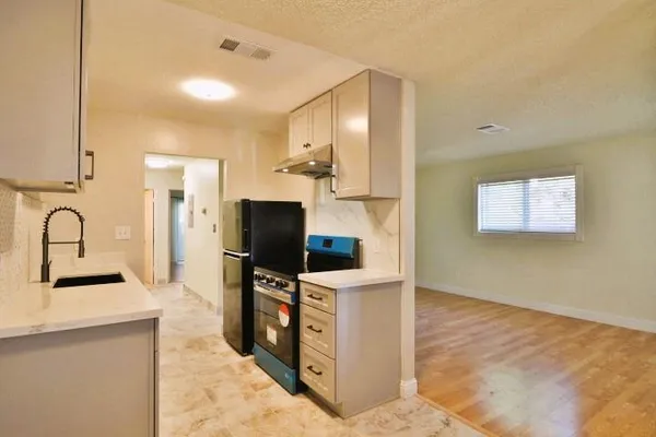 a kitchen with stainless steel appliances a microwave a stove and a refrigerator