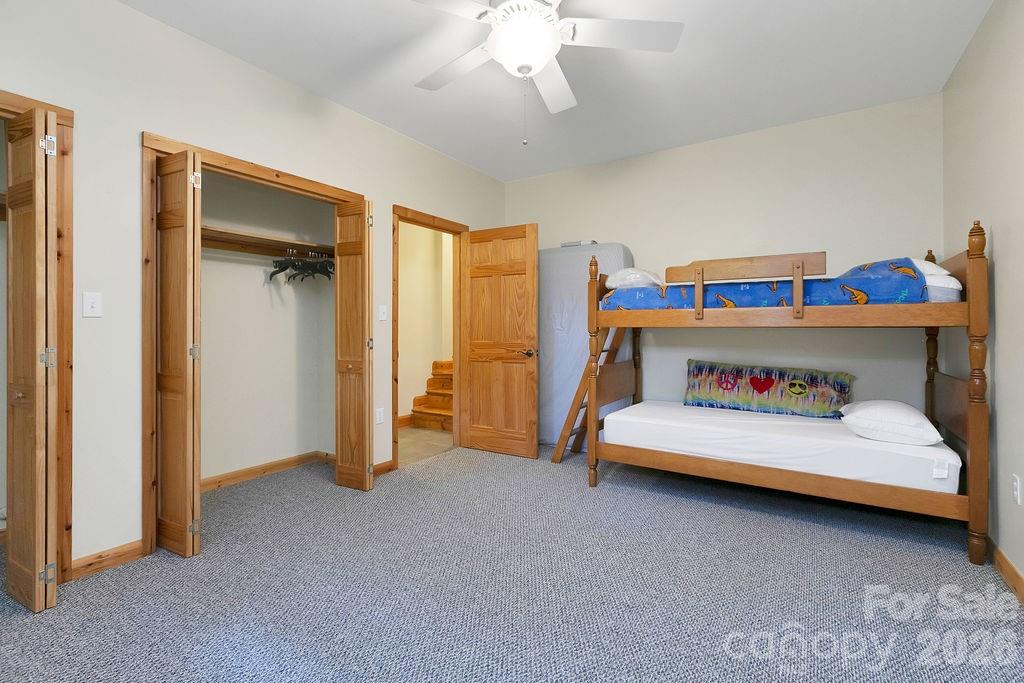 40 Walnut Ridge Road Brevard, NC 28712 - Photo 35 of 47 a bedroom with a bed and a chandelier