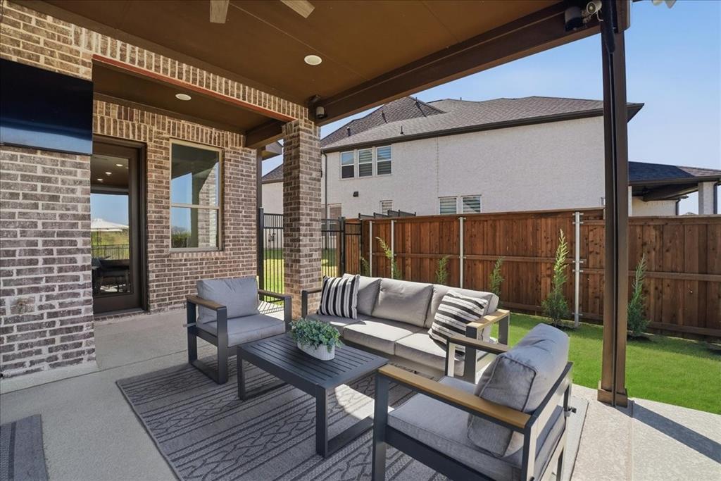 2721 Rotherham Street Prosper, TX 75078 - Photo 26 of 37 a outdoor living area with furniture and a rug