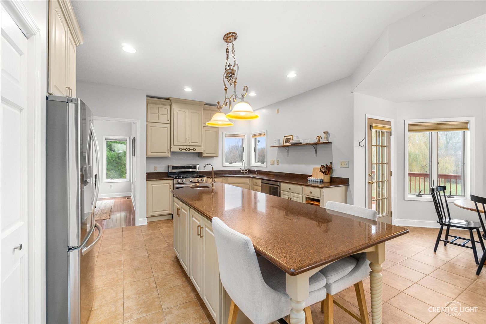 10167 East Deer Creek Lane Rochelle, IL 61068 - Photo 11 of 51 a kitchen with stainless steel appliances granite countertop a stove a sink a oven a dining table and chairs
