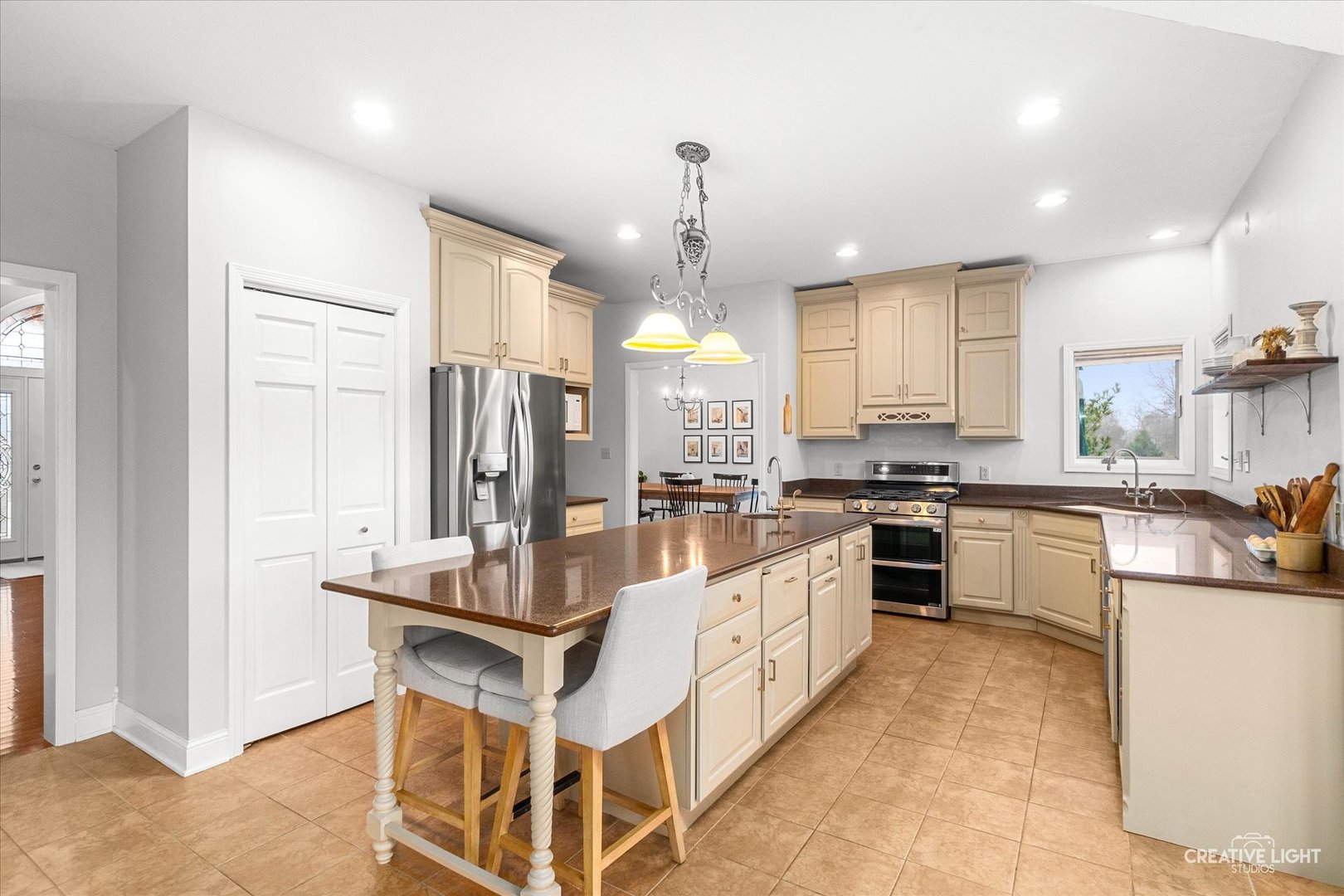10167 East Deer Creek Lane Rochelle, IL 61068 - Photo 12 of 51 a large white kitchen with lots of counter space and chandelier