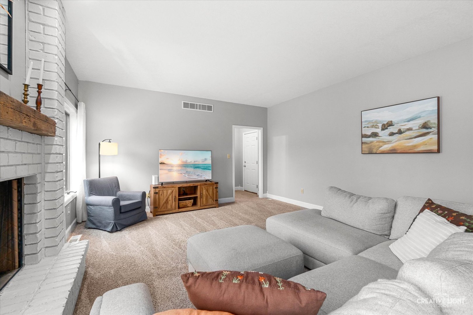 10167 East Deer Creek Lane Rochelle, IL 61068 - Photo 18 of 51 a living room with furniture and a fireplace