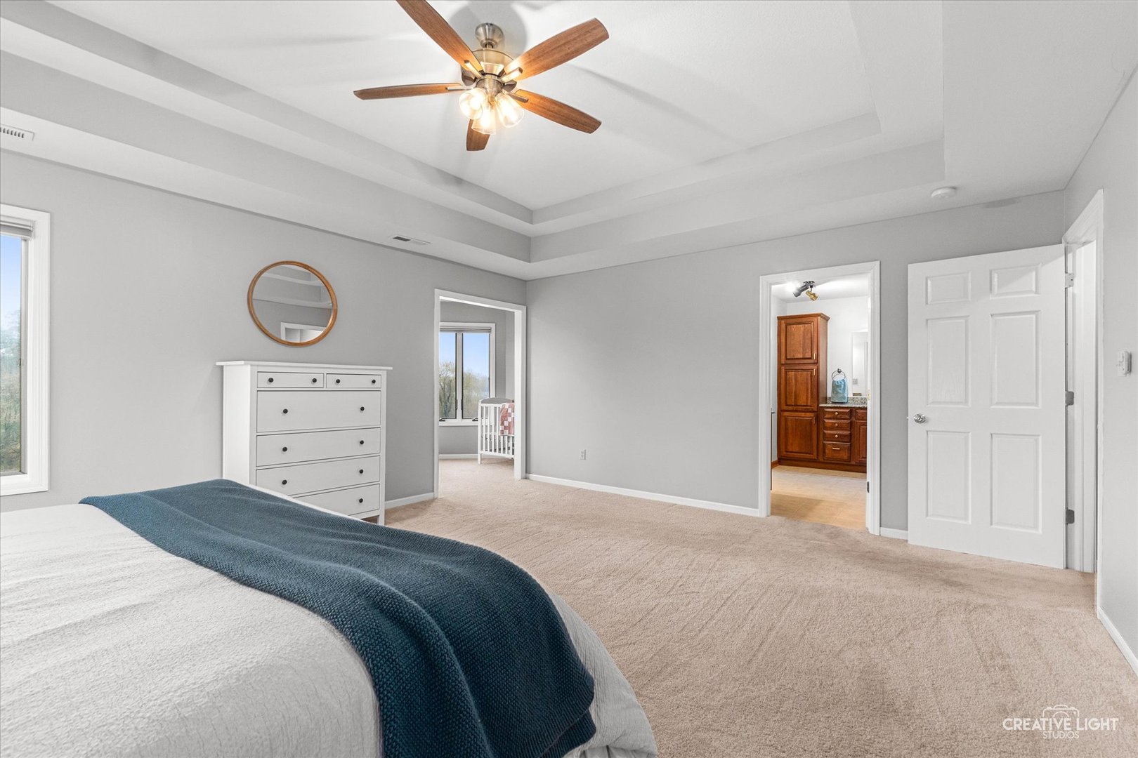 10167 East Deer Creek Lane Rochelle, IL 61068 - Photo 26 of 51 a bedroom with a large bed and a chandelier