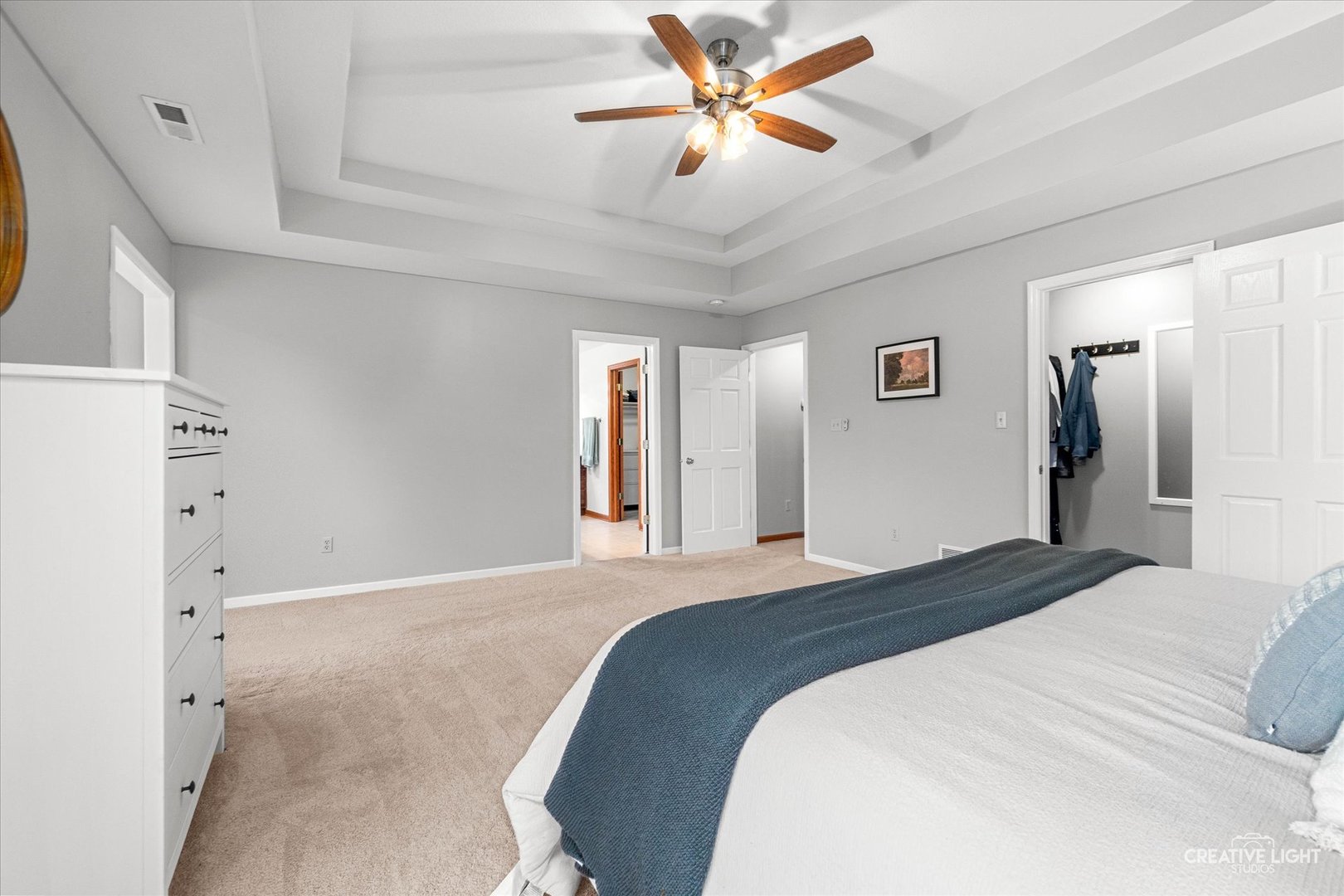 10167 East Deer Creek Lane Rochelle, IL 61068 - Photo 27 of 51 a bedroom with a large bed and a chandelier