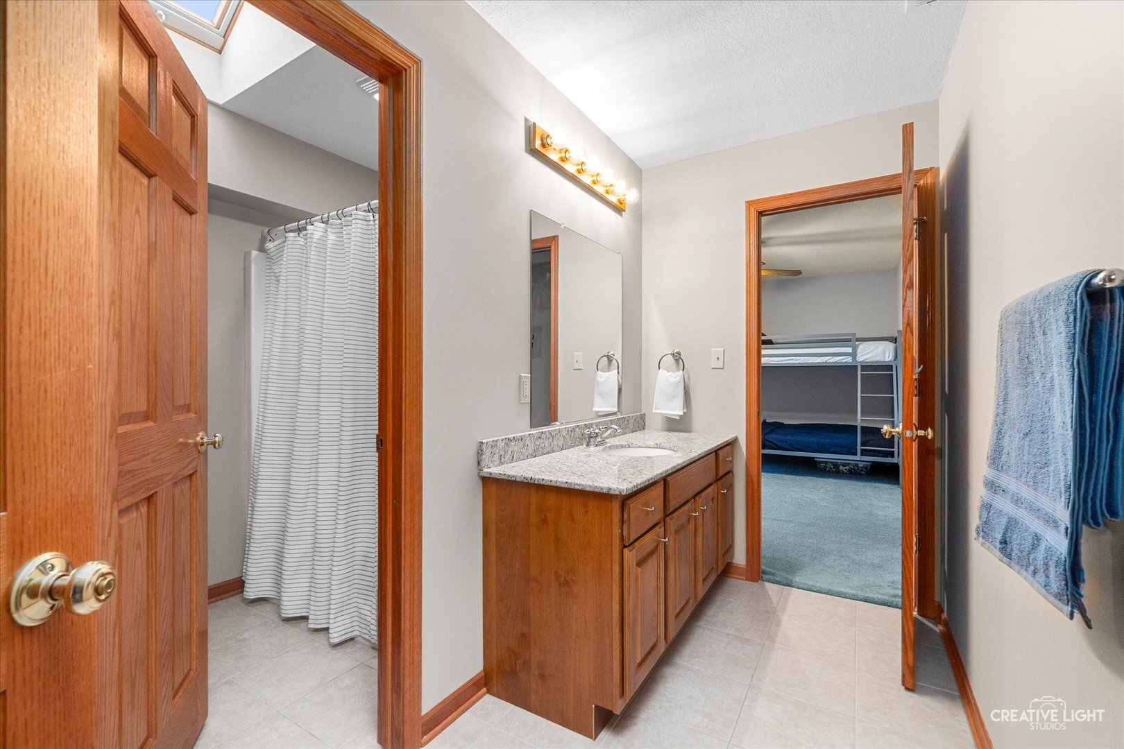10167 East Deer Creek Lane Rochelle, IL 61068 - Photo 35 of 51 a en suite bathroom with a granite countertop sink and a mirror