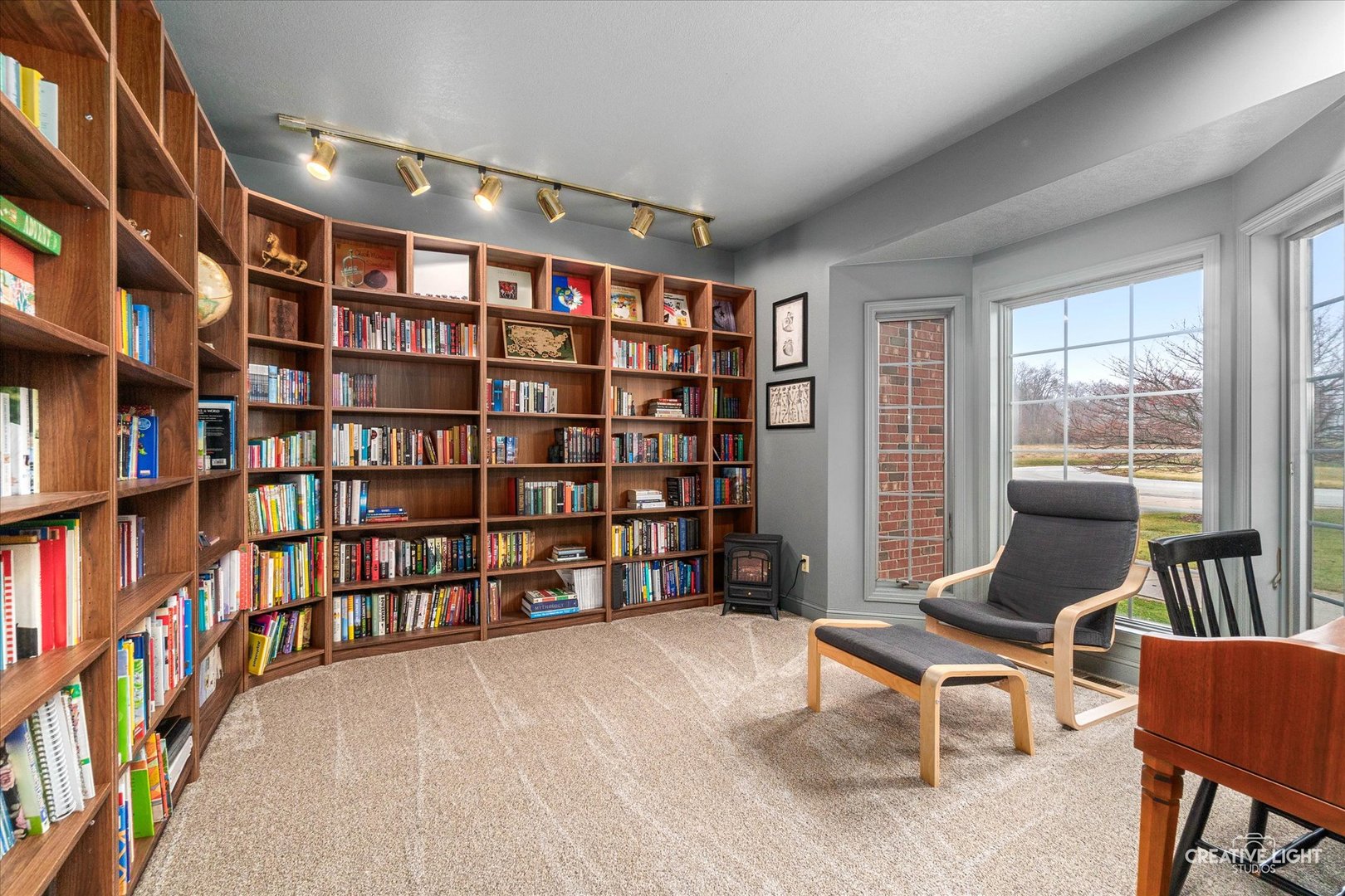 10167 East Deer Creek Lane Rochelle, IL 61068 - Photo 8 of 51 a living room with a book shelf and a book shelf