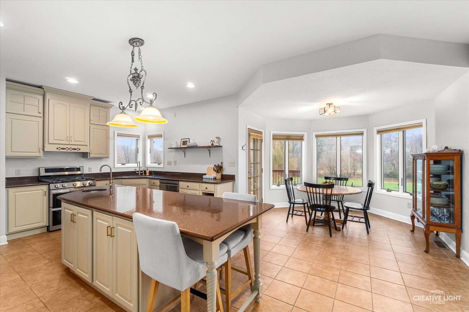 10167 East Deer Creek Lane Rochelle, IL 61068 - Photo 10 of 51 a kitchen with kitchen island a dining table and chairs