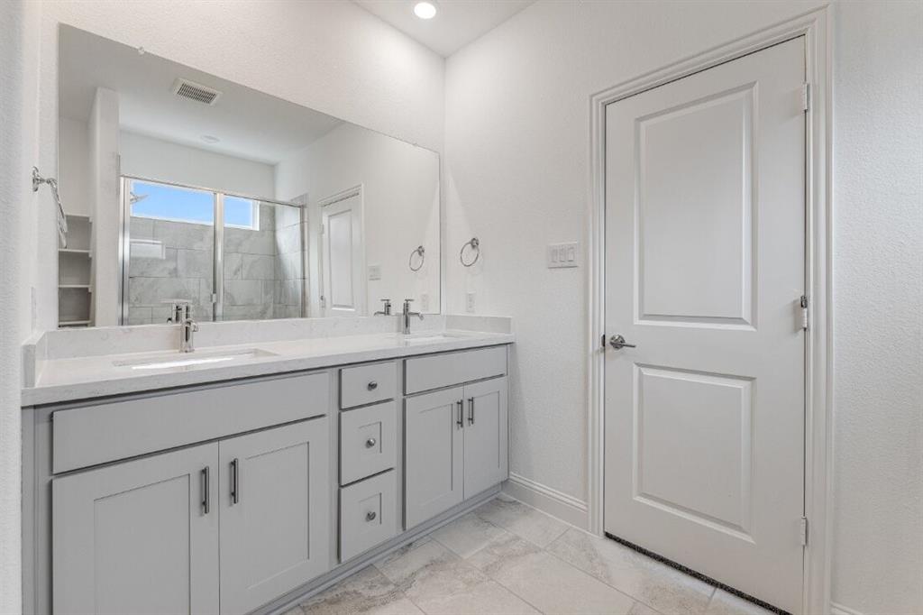 1433 Arciones Road Fort Worth, TX 76052 - Photo 14 of 33 a bathroom with 2 sink and a mirror