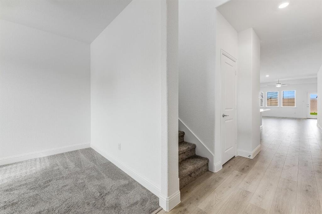 1433 Arciones Road Fort Worth, TX 76052 - Photo 19 of 33 a view of a hallway with wooden floor and staircase