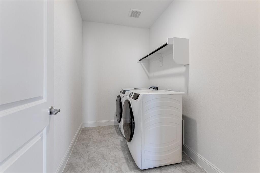 1433 Arciones Road Fort Worth, TX 76052 - Photo 21 of 33 a utility room with a washer and dryer