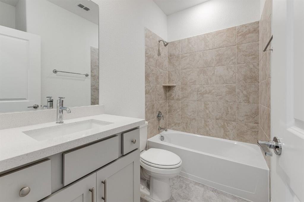 1433 Arciones Road Fort Worth, TX 76052 - Photo 24 of 33 a bathroom with a sink a toilet and a bathtub