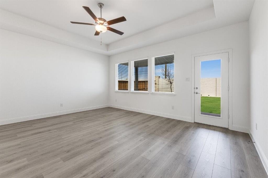 1433 Arciones Road Fort Worth, TX 76052 - Photo 26 of 33 an empty room with wooden floor and windows
