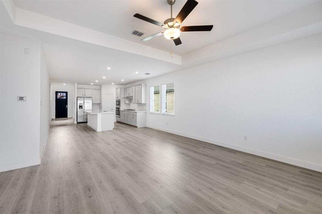 1433 Arciones Road Fort Worth, TX 76052 - Photo 27 of 33 a view of an empty room with wooden floor and a window