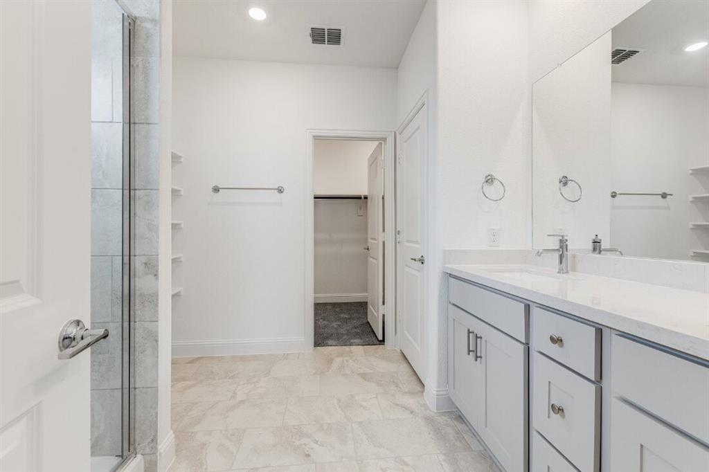 1433 Arciones Road Fort Worth, TX 76052 - Photo 6 of 33 a spacious bathroom with a double vanity sink a mirror and a shower