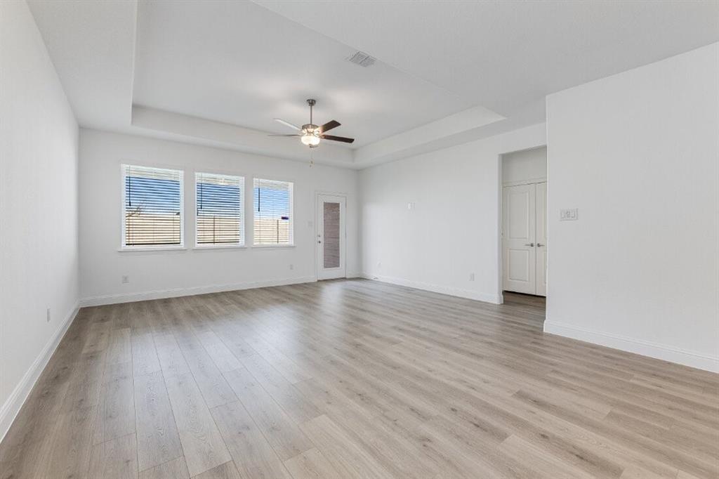 1433 Arciones Road Fort Worth, TX 76052 - Photo 7 of 33 an empty room with wooden floor chandelier and windows