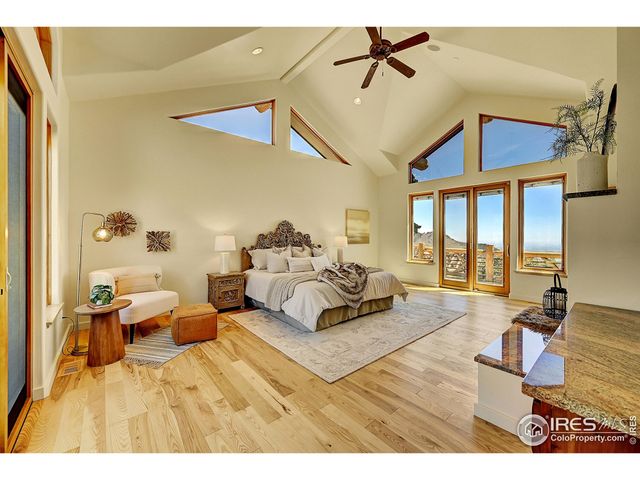 a bedroom with furniture and a flat screen tv