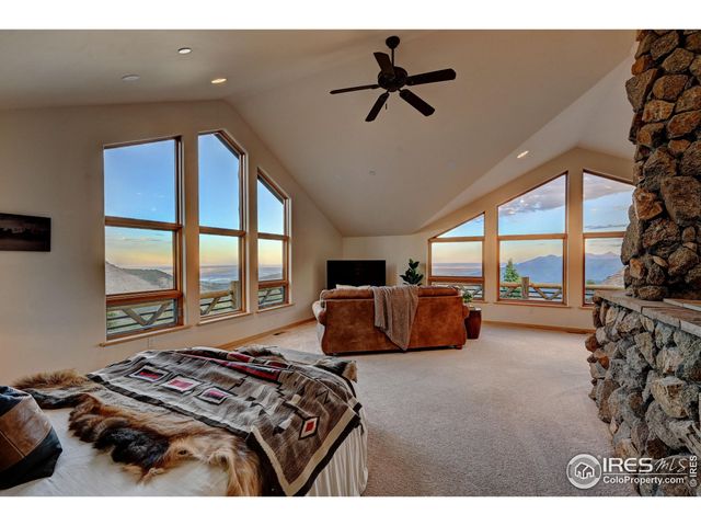 a bed room with a bed and a large window