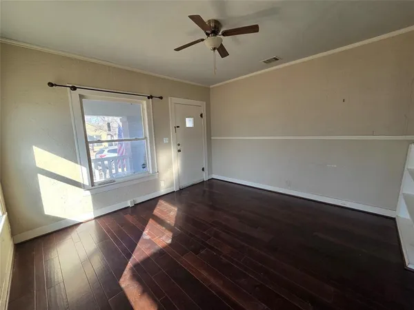 wooden floor in an empty room with a window