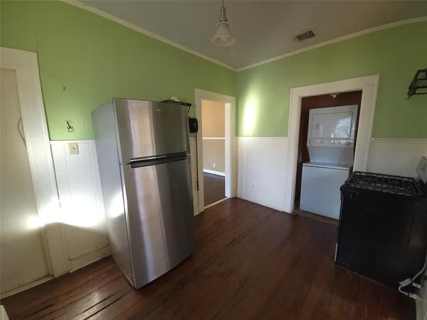 a kitchen with stainless steel appliances granite countertop a refrigerator and a stove