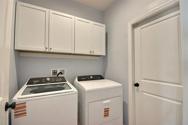 a living room with a bed and a dresser