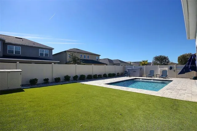 a view of swimming pool with a yard and outdoor seating