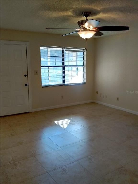 457 Hemlock Street Altamonte Springs, FL 32714 - Photo 2 of 15 an empty room with windows and fan