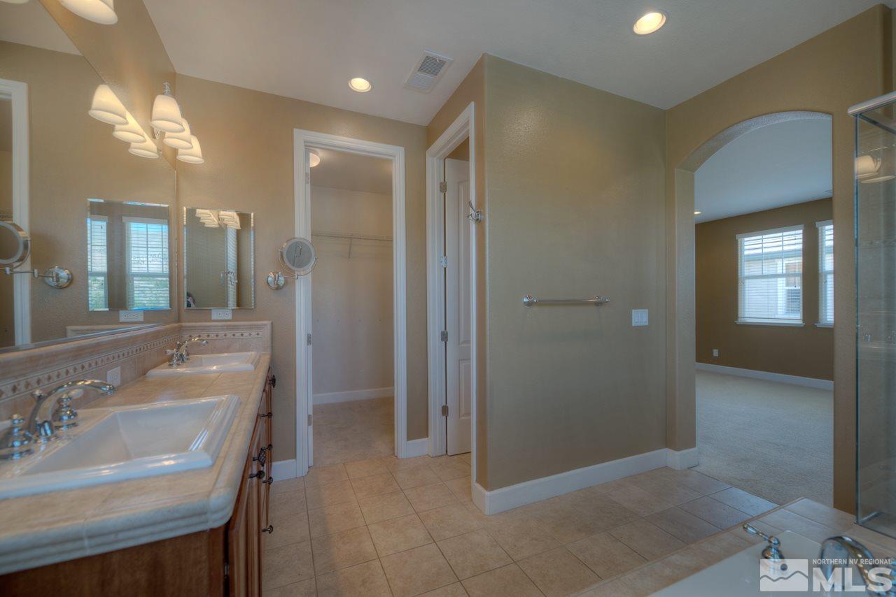 7781 Shalestone Way Reno, NV 89523 - Photo 12 of 24 a bathroom with a sink and a mirror