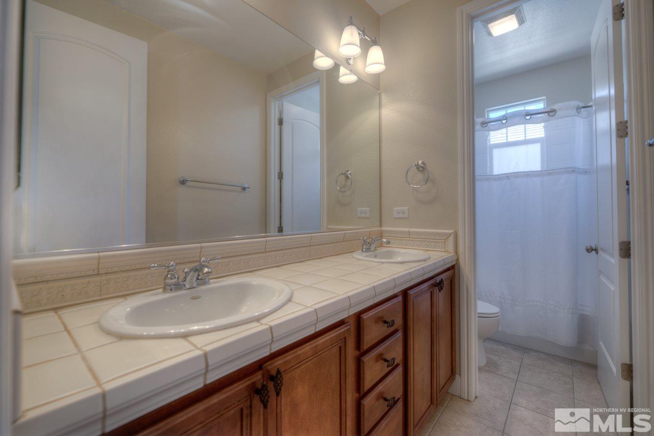 7781 Shalestone Way Reno, NV 89523 - Photo 17 of 24 a bathroom with a sink and a mirror