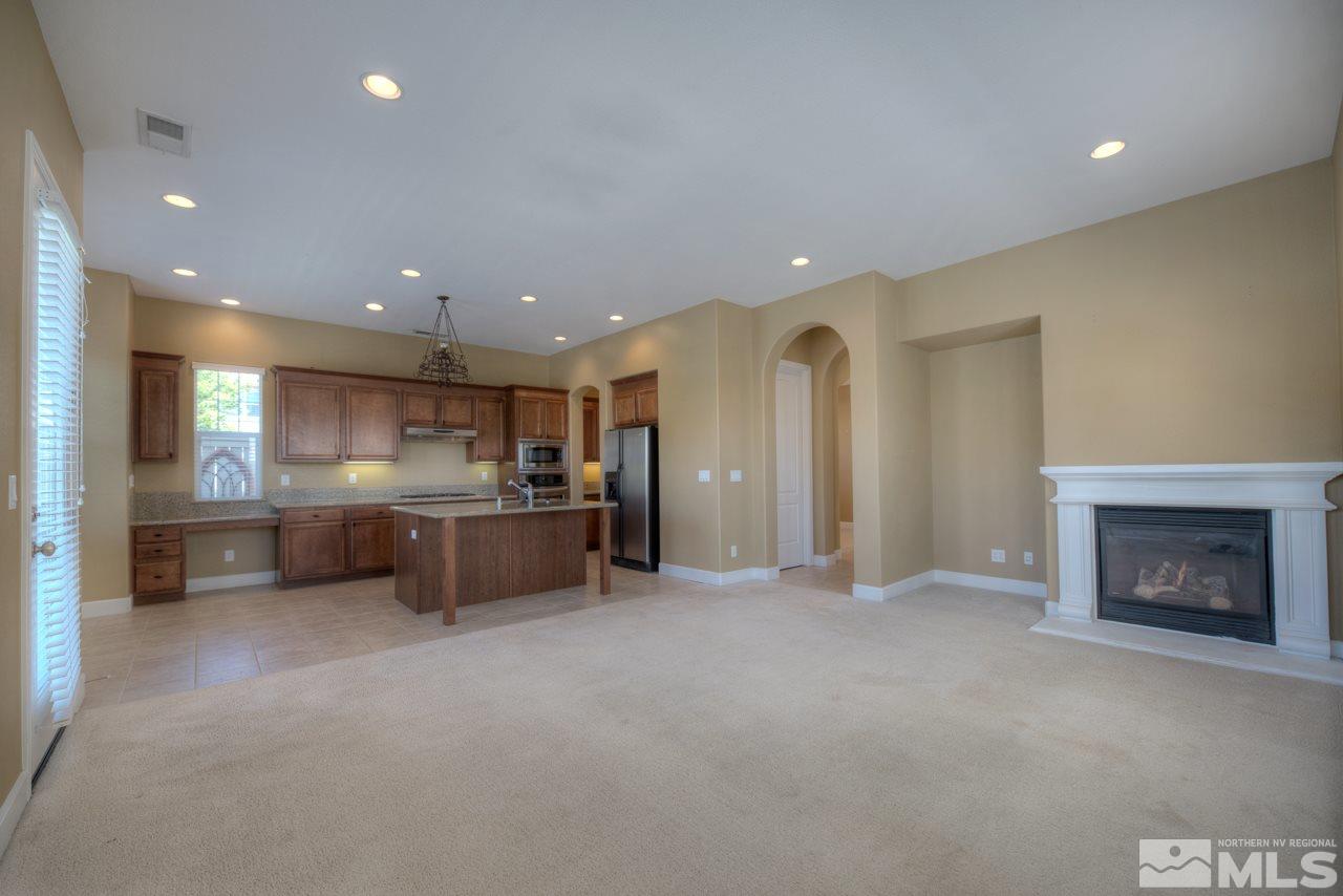 7781 Shalestone Way Reno, NV 89523 - Photo 4 of 24 a view of kitchen with kitchen island and stainless steel appliances