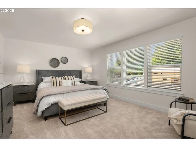 a bed sitting in a bedroom next to a window