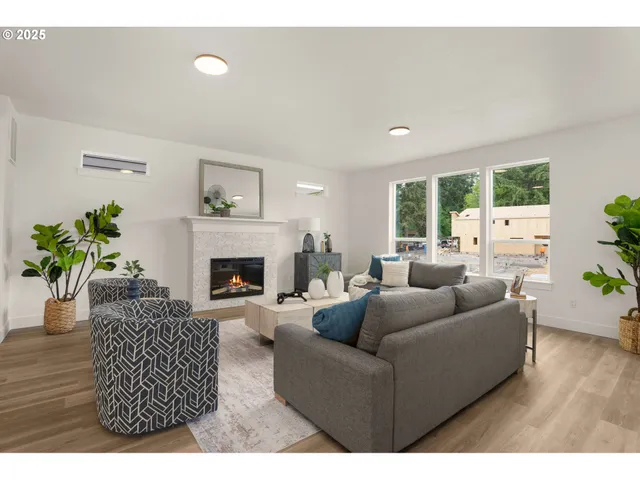 a living room with furniture a fireplace and a potted plant