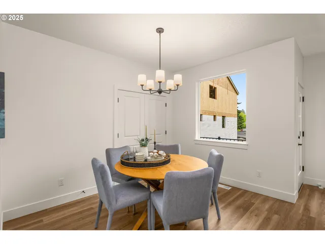 a dining room with furniture a chandelier and wooden floor