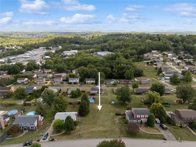 an aerial view of a town with parking