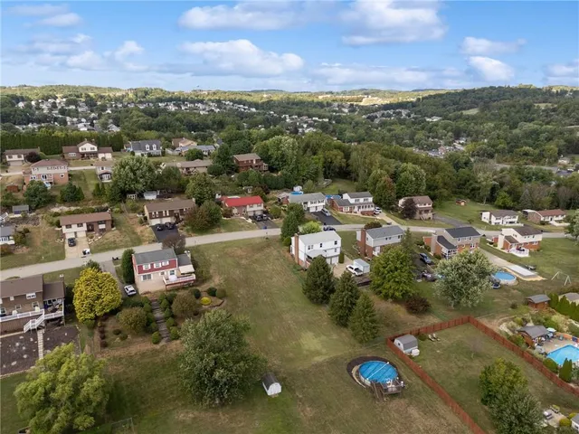 an aerial view of a houses with a lake view