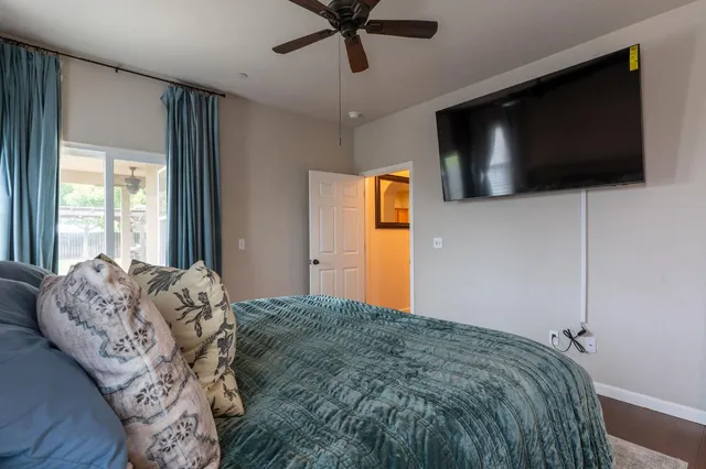 a bed sitting in a bedroom next to a window