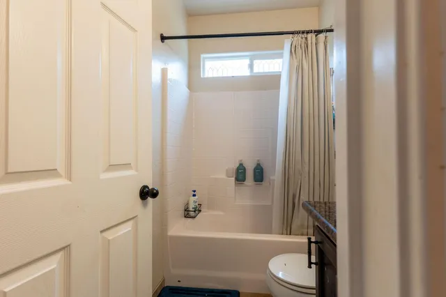 a bathroom with a toilet a sink and bathtub