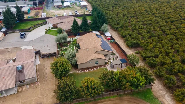 an aerial view of a house with a yard basket ball court and outdoor seating