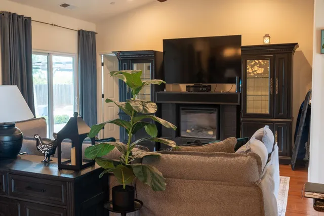 a living room with furniture a fireplace and a flat screen tv