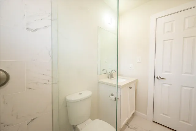 a bathroom with a shower and toilet