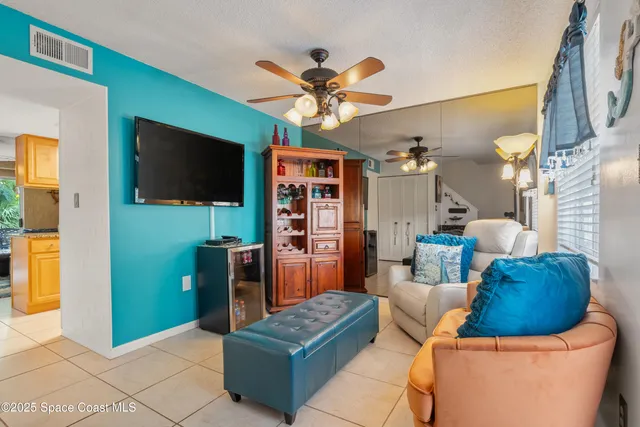 a bedroom with furniture a flat screen tv and a fireplace