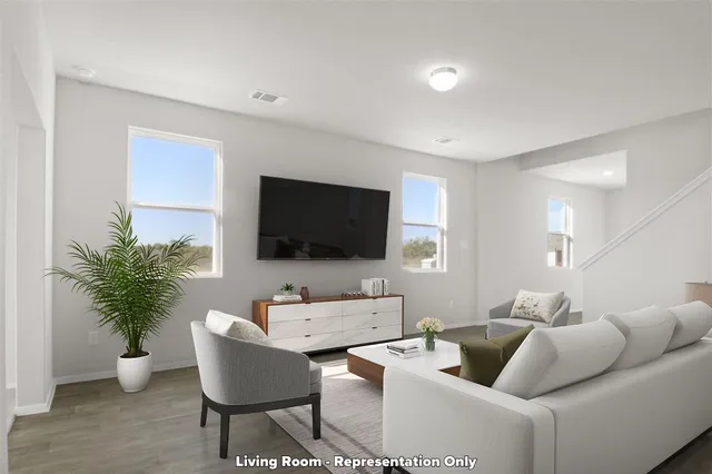 a kitchen with refrigerator and chairs