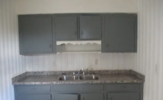 a stove top oven sitting inside of a kitchen