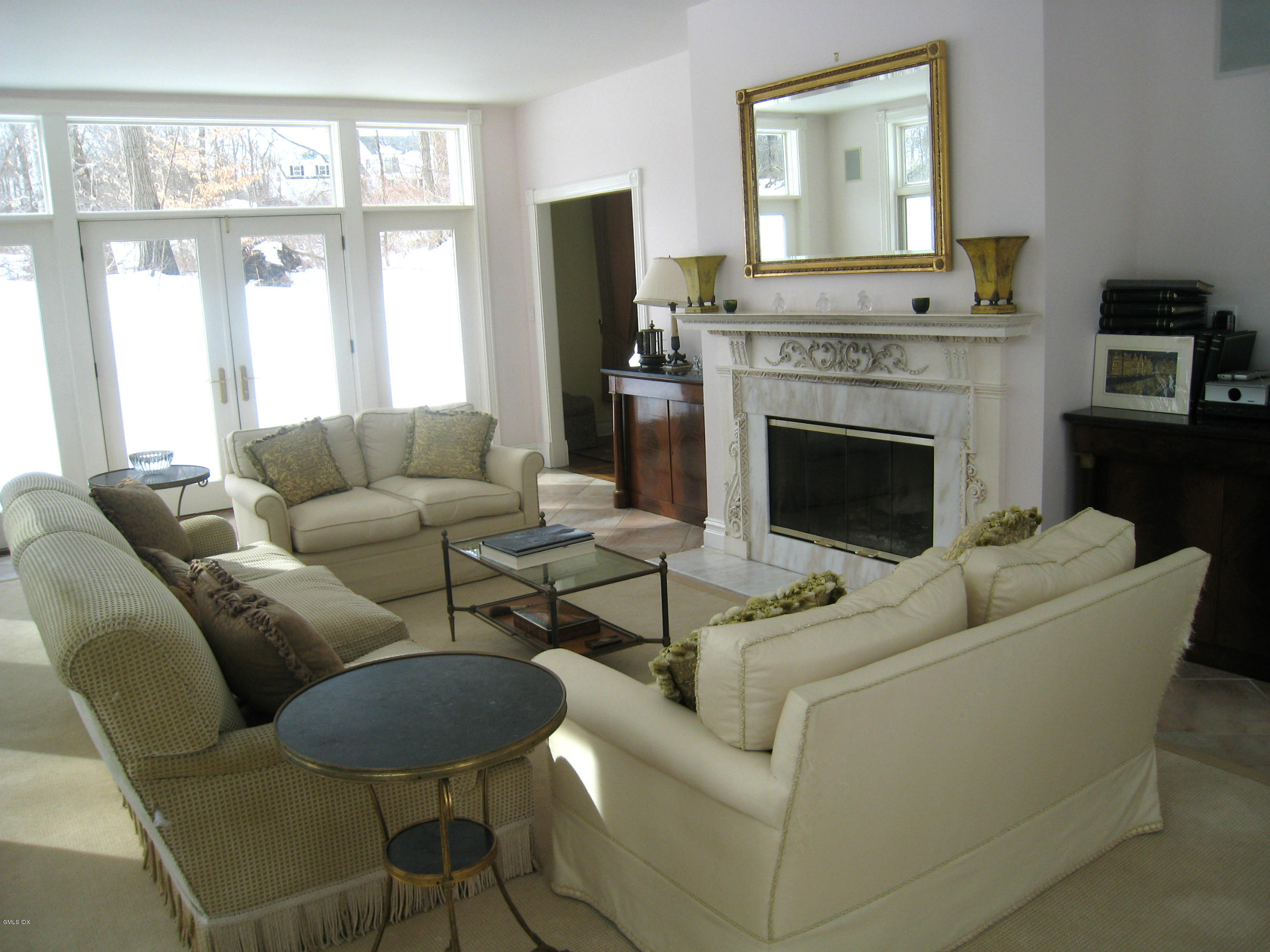 134 Butternut Hollow Road Greenwich, CT 06830 - Photo 3 of 15 a living room with furniture a large window and a fireplace