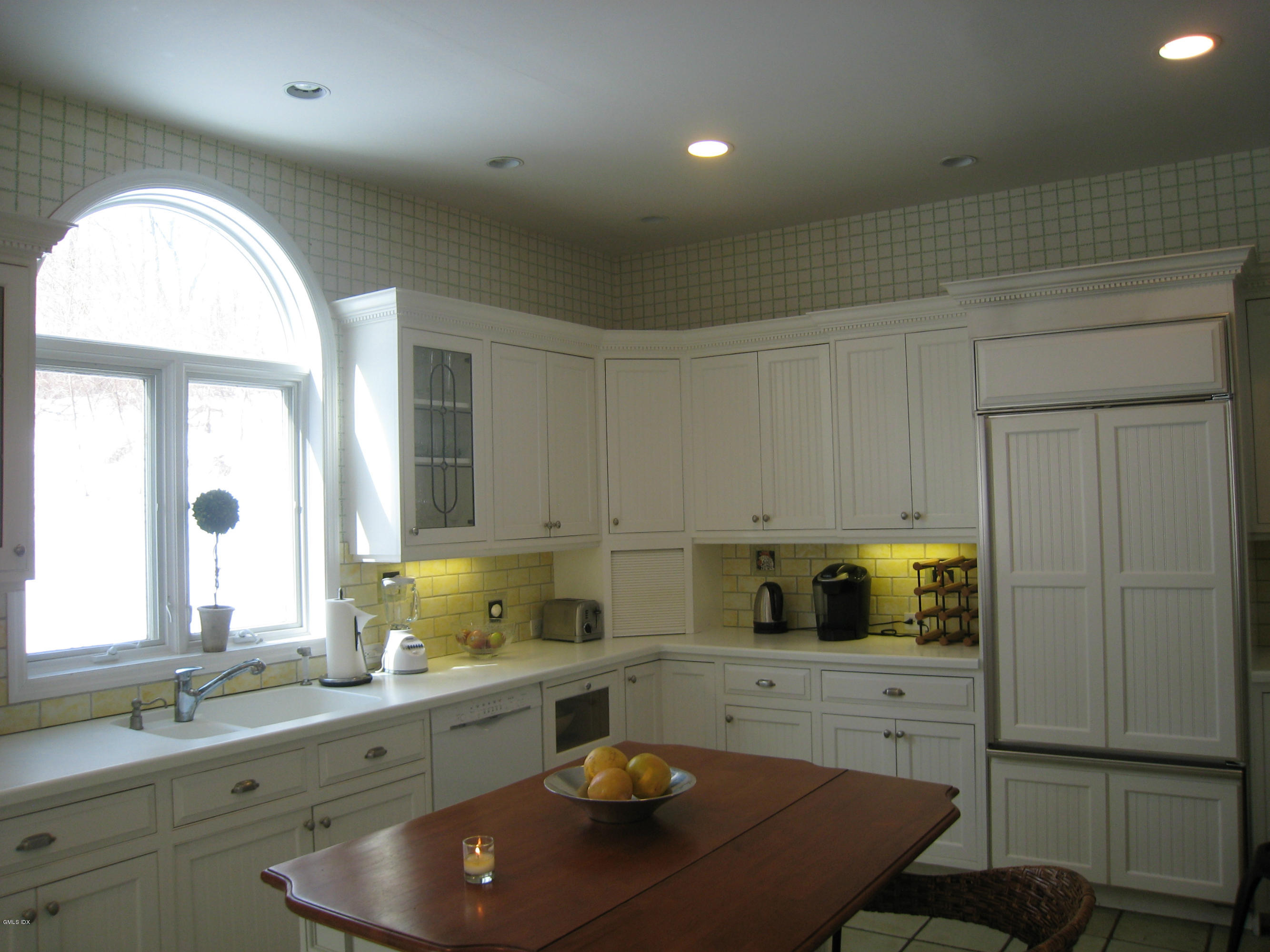 134 Butternut Hollow Road Greenwich, CT 06830 - Photo 5 of 15 a kitchen with a sink a stove a microwave cabinets and a window