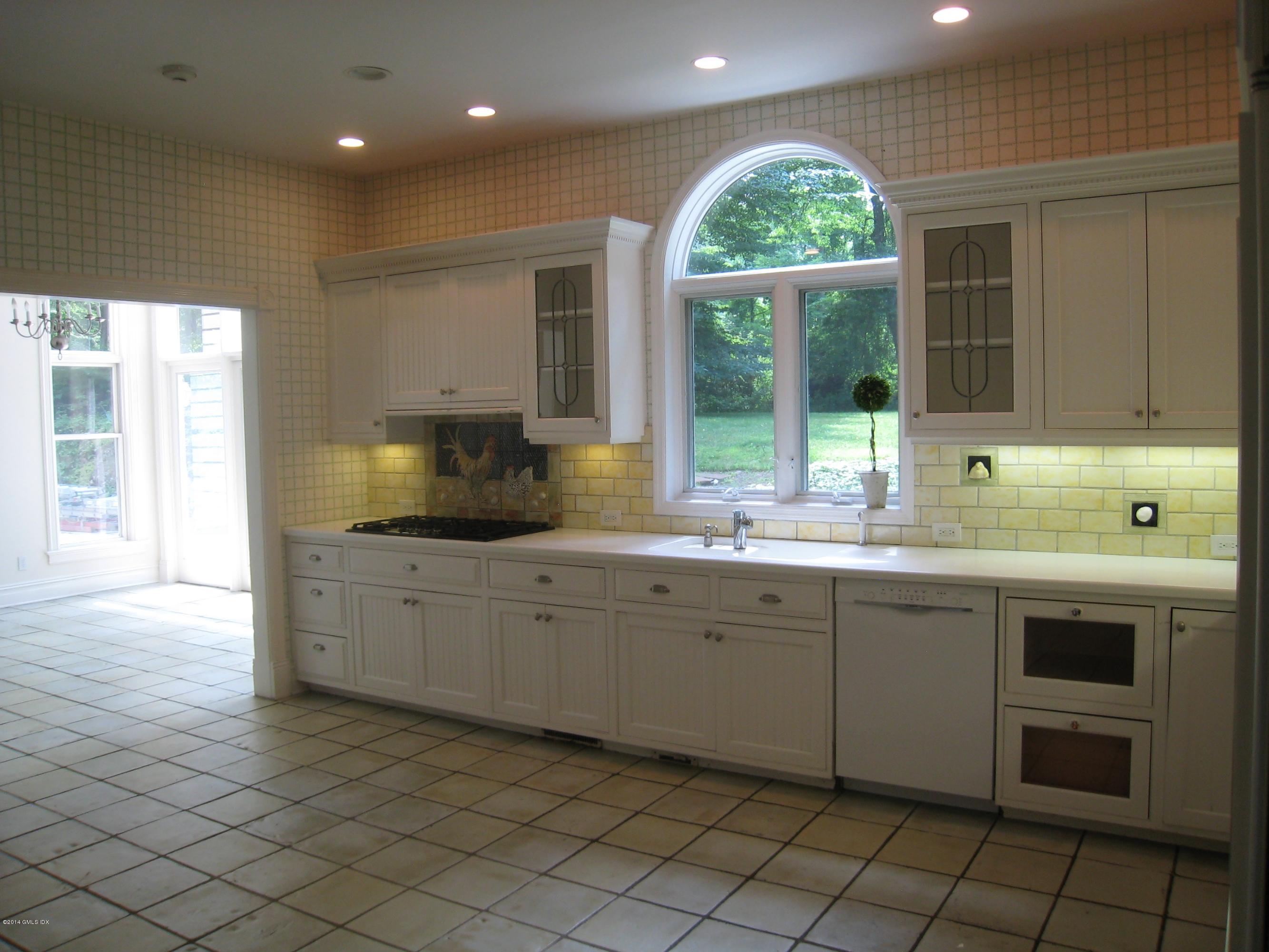 134 Butternut Hollow Road Greenwich, CT 06830 - Photo 9 of 15 a kitchen with a sink window and cabinets