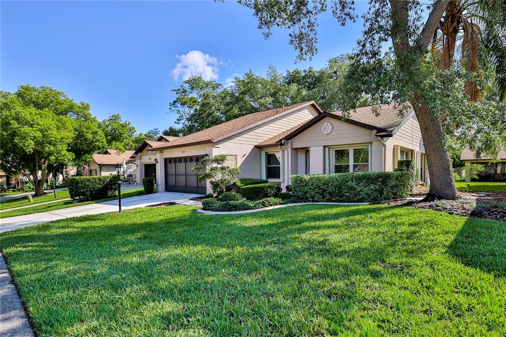 2662 Appleleaf Court Spring Hill, FL 34606 - Photo 3 of 47 a front view of a house with a garden