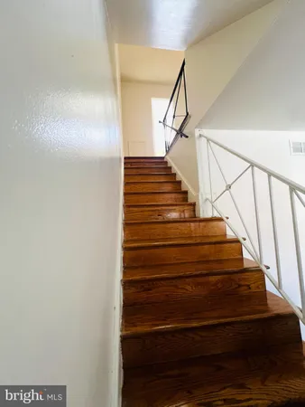 a view of a room with wooden floor and a window
